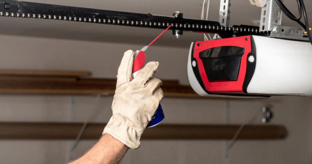 garage door opener being sprayed with lubricant