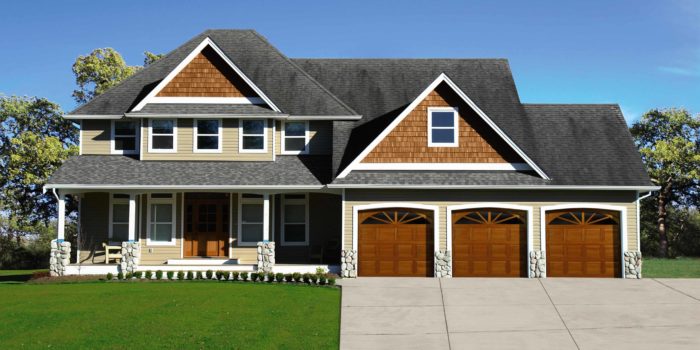 traditional wood garage doors on large home